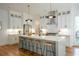 Modern kitchen with island, white cabinets, and hardwood floors at 89 1St Ne Ave, Atlanta, GA 30317