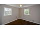 Bright bedroom with hardwood floors and two windows at 9935 La View Cir, Roswell, GA 30075