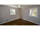 Well-lit bedroom with hardwood floors and two windows at 9935 La View Cir, Roswell, GA 30075