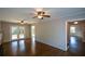 Spacious living room with hardwood floors, fireplace and ceiling fan at 9935 La View Cir, Roswell, GA 30075