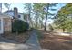 Side yard with a walkway leading to the home, surrounded by landscaping at 9935 La View Cir, Roswell, GA 30075