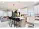 Modern kitchen with white cabinets, large island, and stainless steel appliances at 1506 Avon Sw Ave, Atlanta, GA 30311