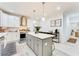 Modern kitchen with white cabinets, large island, and stainless steel appliances at 1506 Avon Sw Ave, Atlanta, GA 30311