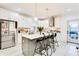 Modern kitchen with white cabinets, large island, and stainless steel appliances at 1506 Avon Sw Ave, Atlanta, GA 30311