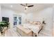 Spacious main bedroom with a king-size bed, patio doors and white accent wall at 1506 Avon Sw Ave, Atlanta, GA 30311