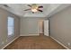 Spacious bedroom with ceiling fan and carpet at 6108 Waterton Dr, Lithonia, GA 30058