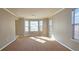 Spacious living room with bay windows and carpeted floor at 6108 Waterton Dr, Lithonia, GA 30058