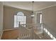 Upstairs landing with chandelier and railing at 6108 Waterton Dr, Lithonia, GA 30058