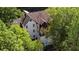 Aerial view of a white house with dark accents, surrounded by tall trees at 6305 River Chase Cir, Atlanta, GA 30328