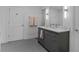 Modern bathroom with gray vanity, white tile shower, and penny tile floor at 6305 River Chase Cir, Atlanta, GA 30328