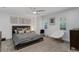 Spacious bedroom with gray bedding, ceiling fan, and plush seating at 6305 River Chase Cir, Atlanta, GA 30328