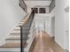 Bright hallway with hardwood floors, built-in shelving, and modern staircase at 6305 River Chase Cir, Atlanta, GA 30328