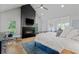 Bright main bedroom featuring a fireplace, king-size bed, and hardwood floors at 6305 River Chase Cir, Atlanta, GA 30328