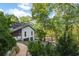 Home's rear elevation showcasing stone pathway and landscaping at 6305 River Chase Cir, Atlanta, GA 30328