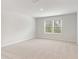 Bright bedroom with carpet and two windows at 7140 Brushwood Bend (Lot 107), Lithonia, GA 30058