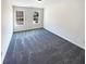 Bedroom with grey carpet and two windows at 7227 Parks Trl, Fairburn, GA 30213