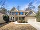 Two-story house with brick and siding, attached garage, and manicured landscaping at 7227 Parks Trl, Fairburn, GA 30213