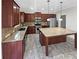 Kitchen boasts an island, granite countertops, and dark wood cabinets at 7227 Parks Trl, Fairburn, GA 30213