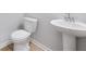 Clean bathroom with pedestal sink and a toilet at 108 Aj Welch Jr Way, Mcdonough, GA 30252