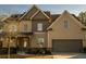 Two-story house with brick and beige siding, attached garage, and landscaping at 2496 Osceola Rd, Lithonia, GA 30058