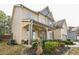 Side view of a two-story home featuring a covered porch and manicured landscaping at 2496 Osceola Rd, Lithonia, GA 30058