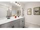 Double vanity bathroom with gray cabinets and a large mirror at 2600 Ravencliff Dr # 161, Austell, GA 30168