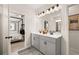 Double vanity bathroom with gray cabinets and view of bedroom at 2600 Ravencliff Dr # 161, Austell, GA 30168