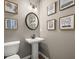 Elegant powder room with pedestal sink and framed art at 2600 Ravencliff Dr # 161, Austell, GA 30168