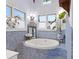 Charming bathroom shows blue-tiled accents, bright windows, and a standalone jacuzzi at 3532 S Fulton Ave, Hapeville, GA 30354