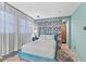 Comfortable bedroom featuring a teal bed frame, natural light, and a cozy ambiance at 3532 S Fulton Ave, Hapeville, GA 30354