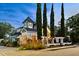 Unique multi-story building with charming architecture, featuring eye-catching paint, and tall, elegant trees at 3532 S Fulton Ave, Hapeville, GA 30354