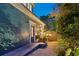 Charming home exterior showcasing a ramp leading to the entrance, accented with lush greenery and inviting lighting at 3532 S Fulton Ave, Hapeville, GA 30354