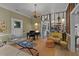 Cozy living room featuring hardwood floors, soft rug, a piano, and decorative chandelier at 3532 S Fulton Ave, Hapeville, GA 30354