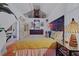 Bright bedroom features vaulted ceiling, decorative headboard, and hardwood floors at 3532 S Fulton Ave, Hapeville, GA 30354