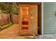Backyard sauna with wood interior, bucket, and adjacent privacy fence and foliage at 3532 S Fulton Ave, Hapeville, GA 30354
