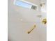 Bright shower space, featuring white tile walls, window, and gold fixtures at 3532 S Fulton Ave, Hapeville, GA 30354