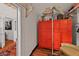 Cozy space featuring a vibrant red wardrobe, decorative hats, and hardwood floors at 3532 S Fulton Ave, Hapeville, GA 30354