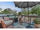 Cozy balcony seating area featuring an umbrella, wicker furniture, and lovely outdoor decor at 3532 South Fulton Ave, Hapeville, GA 30354