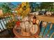 Balcony table setting with wine and glasses offering a view of the pool and greenery at 3532 South Fulton Ave, Hapeville, GA 30354