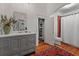 Modern bathroom with gray vanity, red tile shower, and oriental rug at 3532 South Fulton Ave, Hapeville, GA 30354