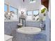 Bright bathroom featuring a soaking tub with blue mosaic tile accents and natural light at 3532 South Fulton Ave, Hapeville, GA 30354