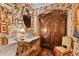 Elegant bathroom with floral wallpaper, antique vanity, and a large armoire at 3532 South Fulton Ave, Hapeville, GA 30354