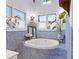 A bathroom with a sunken tub, blue mosaic tilework, and lots of natural light at 3532 South Fulton Ave, Hapeville, GA 30354