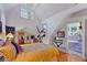 Cozy bedroom with unique architecture, a slanted ceiling, and an adjacent tiled bathroom at 3532 South Fulton Ave, Hapeville, GA 30354