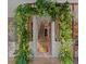 Elegant foyer with an arched doorway covered in lush greenery and a view of the staircase at 3532 South Fulton Ave, Hapeville, GA 30354