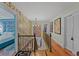 Bright hallway with hardwood flooring, floral wallpaper, and doorways to various rooms of the house at 3532 South Fulton Ave, Hapeville, GA 30354