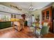 Charming kitchen with green and white cabinets, an island, and a dining area with unique chairs at 3532 South Fulton Ave, Hapeville, GA 30354