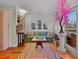 Bright living room featuring hardwood floors, vintage decor, and unique design elements at 3532 South Fulton Ave, Hapeville, GA 30354