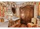 Charming powder room with floral wallpaper, a washstand sink, an antique armoire, and hardwood flooring at 3532 South Fulton Ave, Hapeville, GA 30354