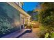 Tranquil side yard featuring a smooth concrete ramp, lush garden foliage, and ambient outdoor lighting at 3532 South Fulton Ave, Hapeville, GA 30354